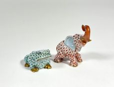 Two Herend porcelain models of animals comprising: an elephant with upraised trunk in coral and a