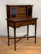 An Edwardian mahogany bonheur de jour, the superstructure with brass gallery, boxwood stringing, and