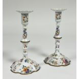 A pair of Staffordshire painted enamel candlesticks, last quarter of the 18th century, in two