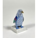 A Herend porcelain model of a penguin, in the blue scale pattern, modelled on a square base, printed