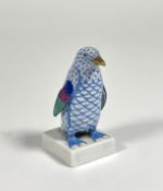 A Herend porcelain model of a penguin, in the blue scale pattern, modelled on a square base, printed