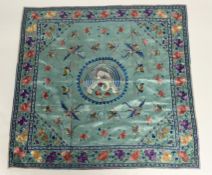 A Chinese embroidered silk square, early 20th century, worked to both sides in coloured threads with