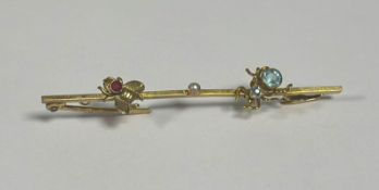 An early 20th century 9ct gold gem-set bug bar brooch, the knife-edge bar set centrally with a