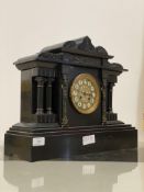 A Victorian slate mantel clock of architetchural form, inset with cast metal frieze depicting