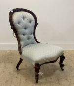 A Victorian carved walnut framed slipper chair with button back upholstery moving on castors H90cm
