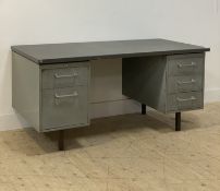 A mid century pressed steel machinists desk, the rectangular top above five drawers, raised on