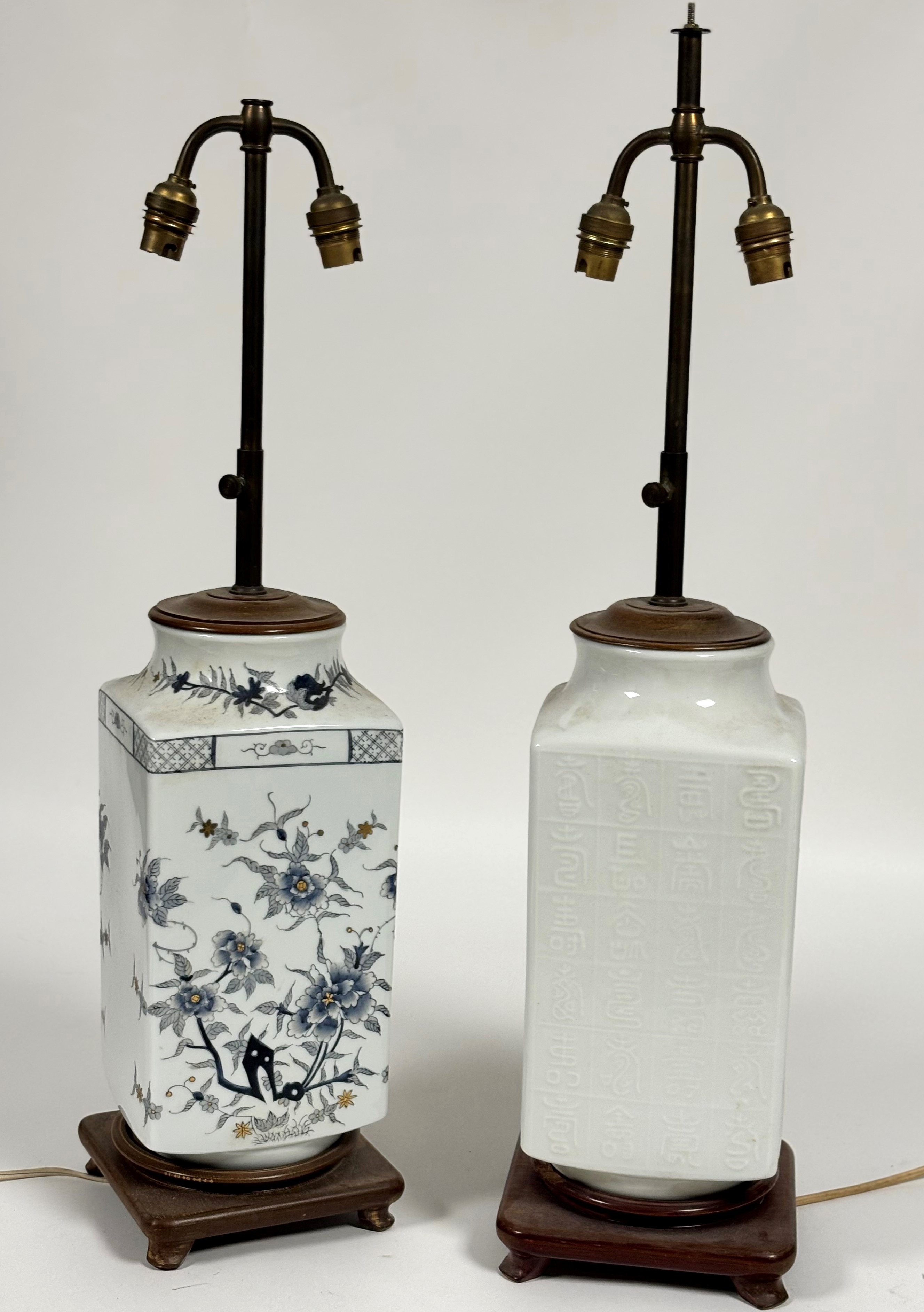 A white ceramic table lamp decorated with Chinese letters to body raised on a wooden base (small