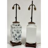 A white ceramic table lamp decorated with Chinese letters to body raised on a wooden base (small