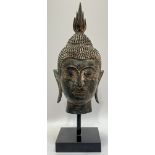 An U-Thong style Thai bronze bust of Shakyamuni Budhha mounted on a square base (h- 36cm)