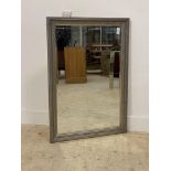 A silvered composition framed wall hanging mirror with bevelled glass plate 104cm x 74cm