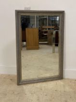 A silvered composition framed wall hanging mirror with bevelled glass plate 104cm x 74cm