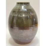 A large studio pottery stoneware vase glazed in red/brown and green, the mouth with nuka/dolomite