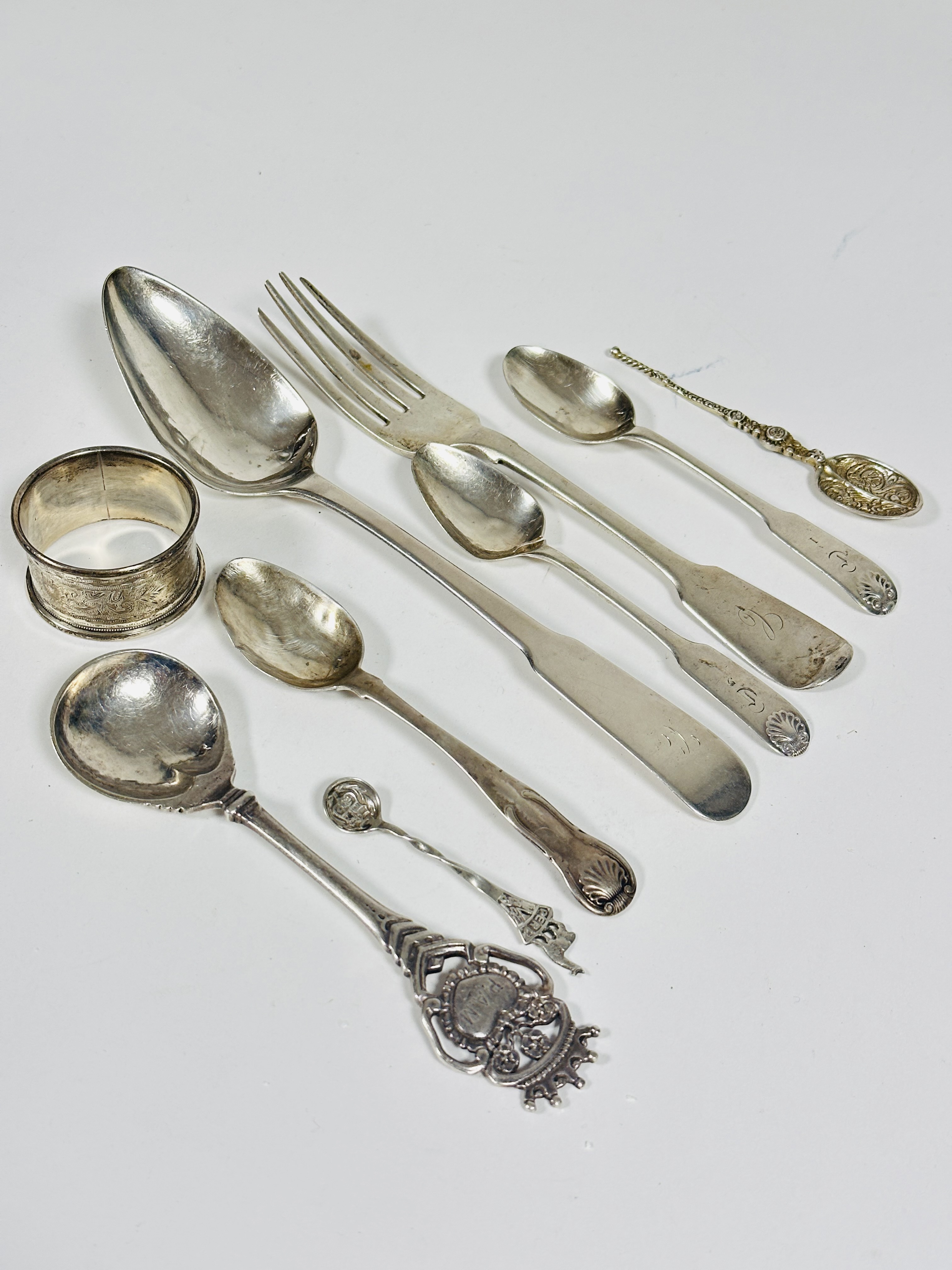 A collection of silver and white metal flatware including a provincial silver fiddle pattern table