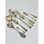 A collection of silver and white metal flatware including a provincial silver fiddle pattern table