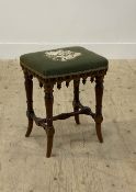 A Victorian walnut framed music stool, the upholstered top with green velvet cover above an