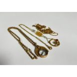 A collection of five gilt metal chains, an Edwardian compass pendant on gilt metal belcher style