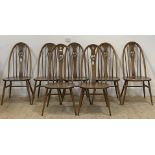 Ercol, a set of seven stained beech and elm hoop and spindle back dining chairs H102cm