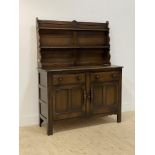 Ercol, a stained oak dresser, with a two height plate rack above base fitted with two drawers and