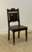 A Victorian oak hall chair, the crest rail on spindle gallery above panelled back and seat, raised