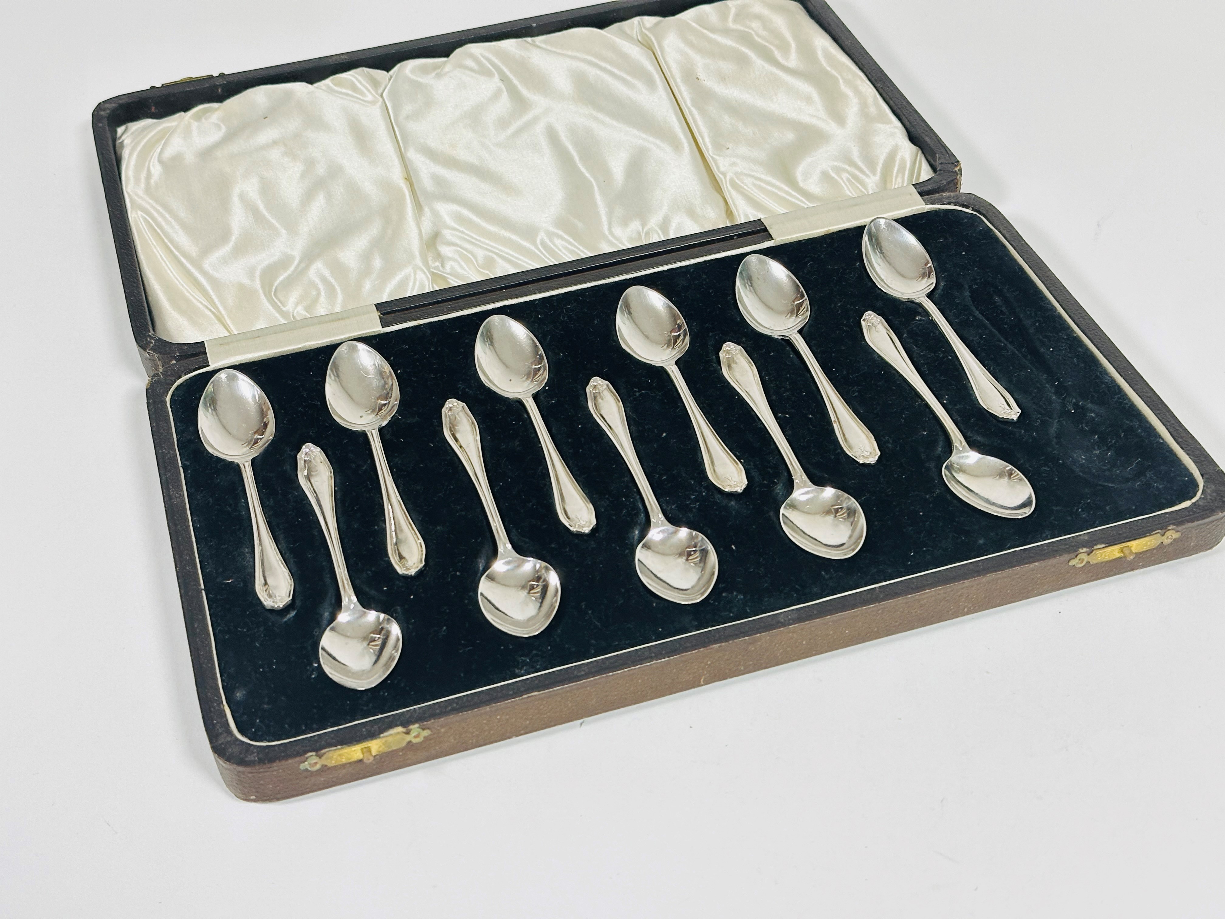 A set of eleven Sheffield silver tea spoons with hair bell cast handles, complete with fitted