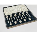 A set of eleven Sheffield silver tea spoons with hair bell cast handles, complete with fitted