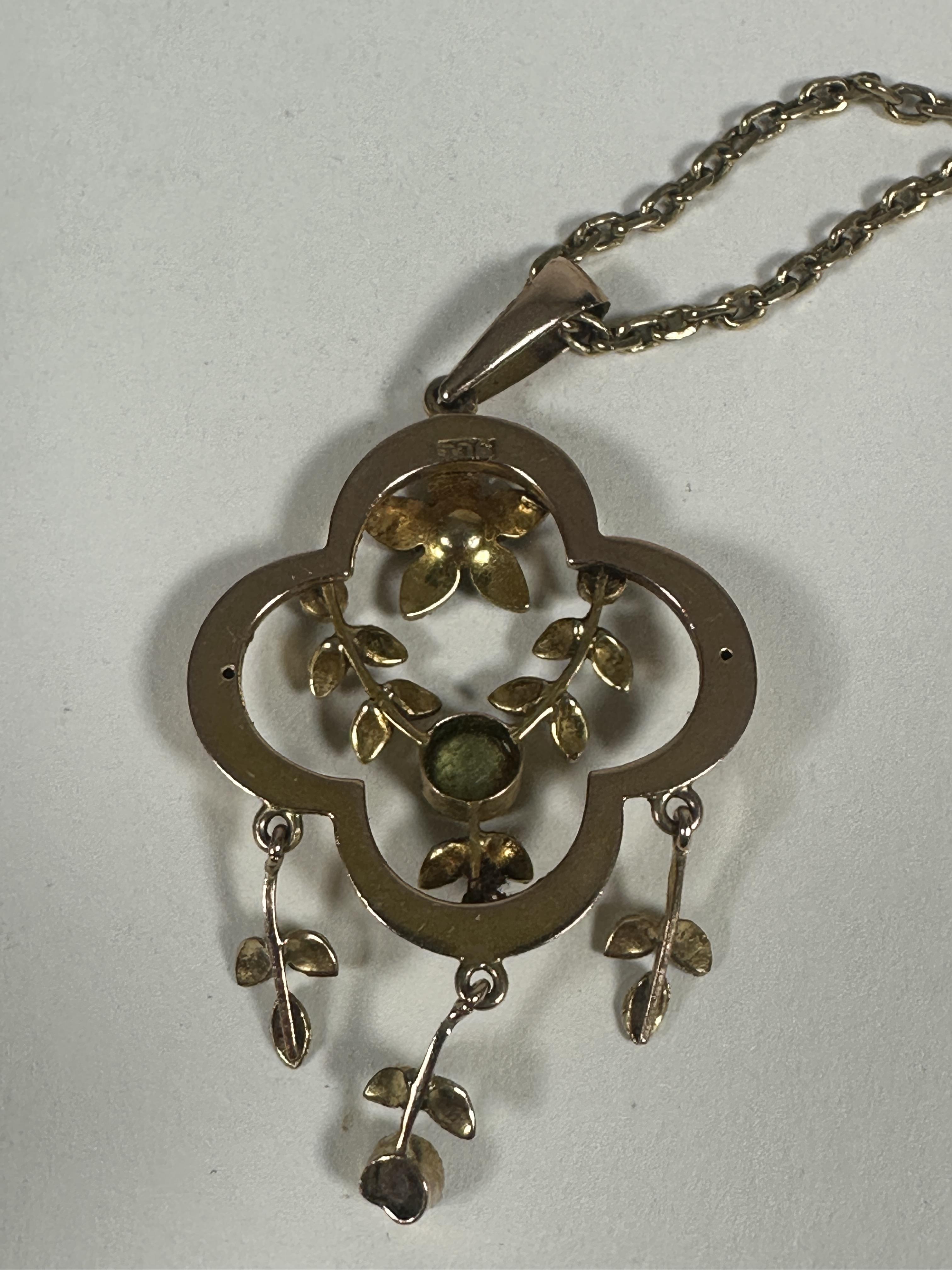 An Edwardian 9ct gold open work pendant of oval shaped design set Peridot, seed pearl flowers and - Image 2 of 2