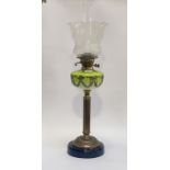 An Edwardian cast brass and glass oil lamp, the circular lacquered base under a reeded column