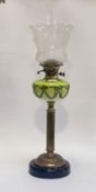 An Edwardian cast brass and glass oil lamp, the circular lacquered base under a reeded column