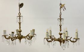 A pair of floral cast gilt brass chandeliers, first half of the 20th century, each with a faceted