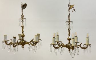 A pair of floral cast gilt brass chandeliers, first half of the 20th century, each with a faceted