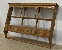 A Victorian style pine delf rack, with two open shelves above six spice drawers and two rows of