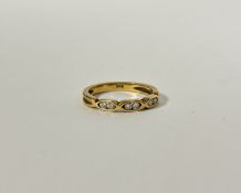 A 18ct gold ring set three pairs of Diamond points in open chain style setting, K/L. 2.6g