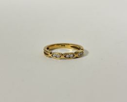 A 18ct gold ring set three pairs of Diamond points in open chain style setting, K/L. 2.6g