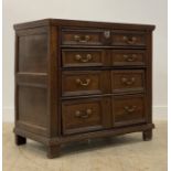 A late 17th century oak chest of drawers, the top with moulded edge above four long graduated and