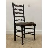 A late 19th century stained oak ladder back chair with drop in seat pad, raised on turned supports