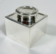 A Edwardian Birmingham silver Capstan desk ink well with circular hinged top and square base with