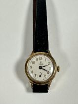 A lady's 9ct gold Tudor manual wind wrist watch, the silvered dial with Roman numerals and seconds