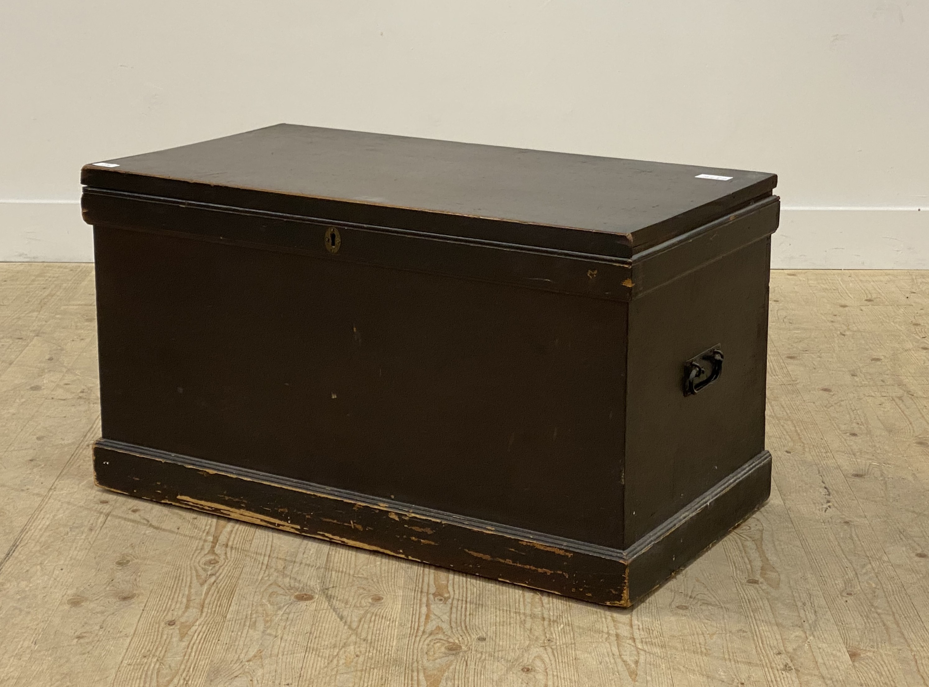 A 19th century stained pine blanket box, the hinged lid (locked no key) above carry handle to each