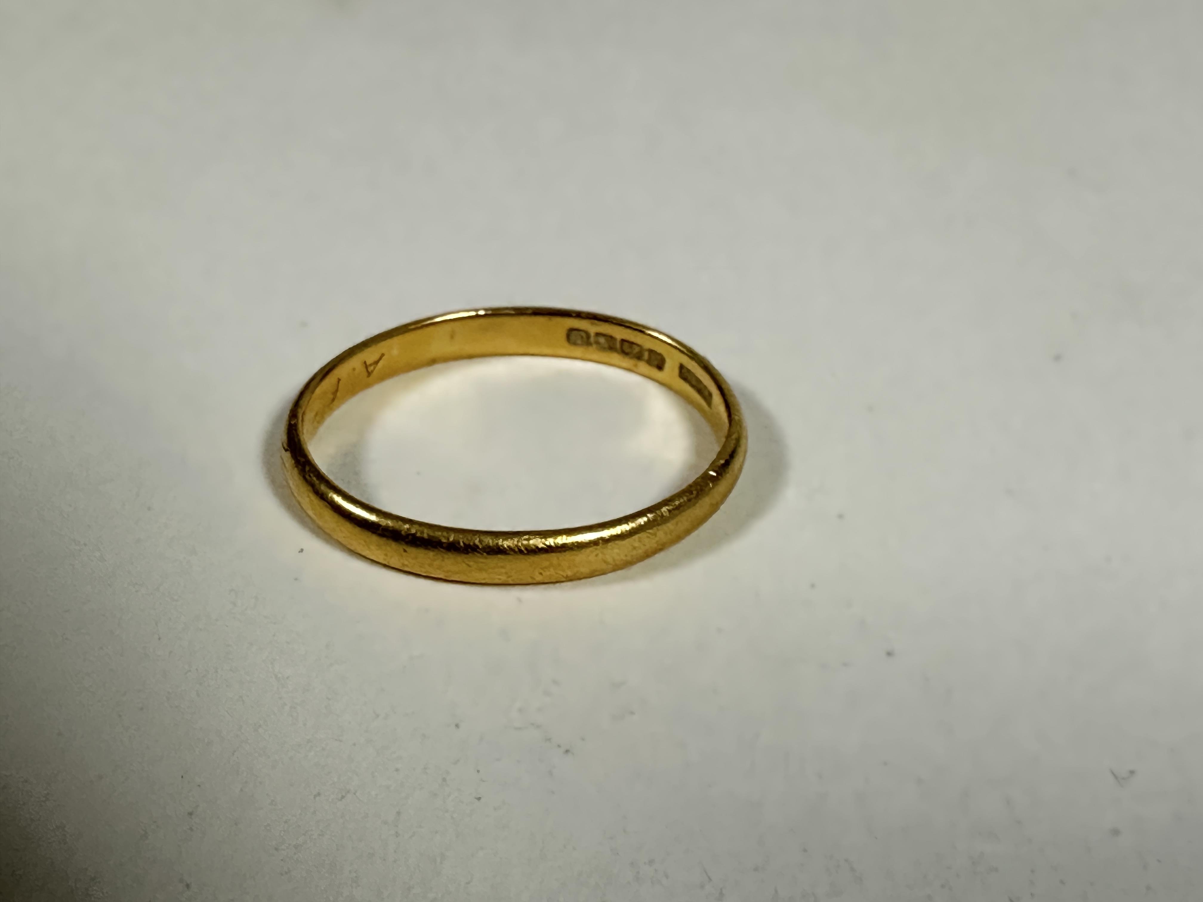 A 22ct gold wedding band of oval shape, M. 2.49g