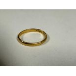 A 22ct gold wedding band of oval shape, M. 2.49g