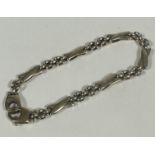 a 9ct gold X and chain link bracelet with lobster clasp fastening, shows no signs of damage or