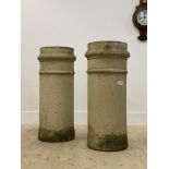 A pair of 19th century terracotta chimney pots of cylindrical outline, H76cm