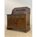 An Edwardian mahogany wash stand, the raised back with open shelf inset with rouge marble, above a