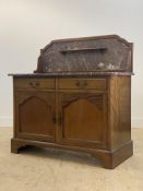 An Edwardian mahogany wash stand, the raised back with open shelf inset with rouge marble, above a