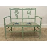 A green painted two seat hall bench, twin splat back over upholstered seat, raised on turned