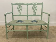 A green painted two seat hall bench, twin splat back over upholstered seat, raised on turned