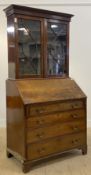 A George III mahogany bureau bookcase, the (associated) top with two astragal glazed doors enclosing