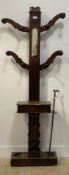 A Victorian walnut hall stand, the mirrored back with eight turned coat hooks above a glove box