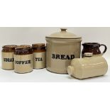 A group of glazed stoneware kitchenalia comprising three jars labelled 'Tea', 'Sugar', and '