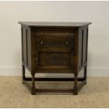 An oak creedence or hall cabinet of 17th century design, fitted with two drawers above a lozenge